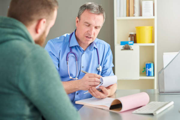 Doctor writing prescription for nicotine inhaler