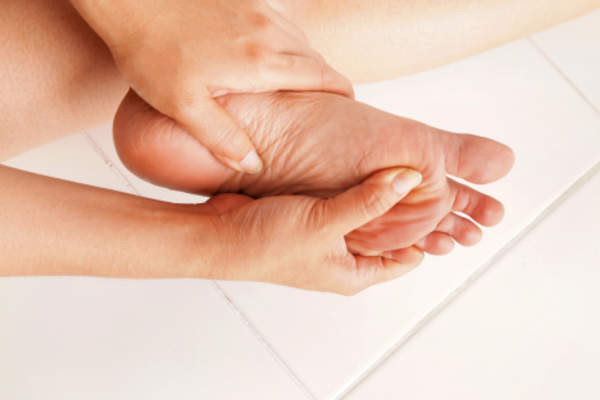 Woman rubbing her feet.