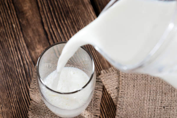 whole milk pouring into glass