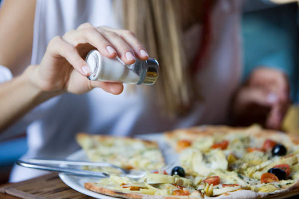 putting salt on food