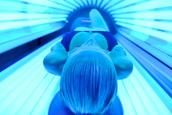 Woman in tanning bed