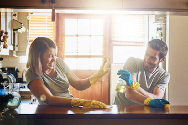Couple playing around while cleaning.