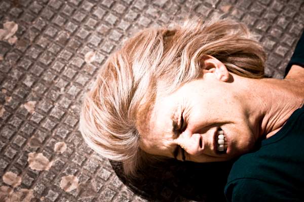 Woman on the floor having a seizure.