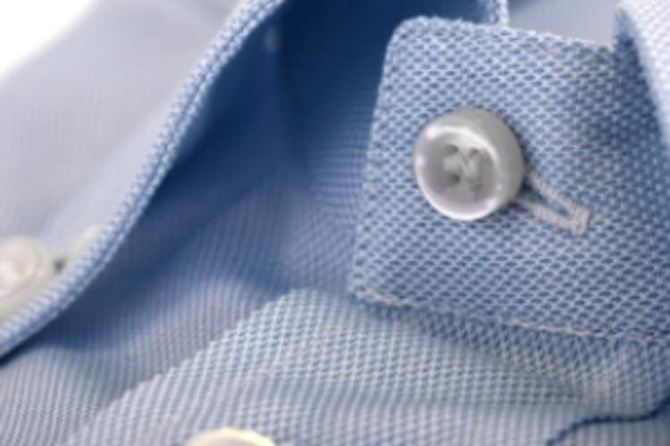 Blue button down shirt close up.