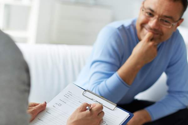 Man at therapist's office in good conversation.