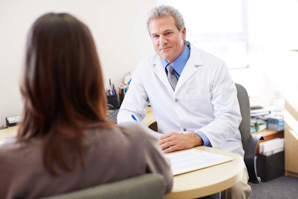 woman talking to doctor image