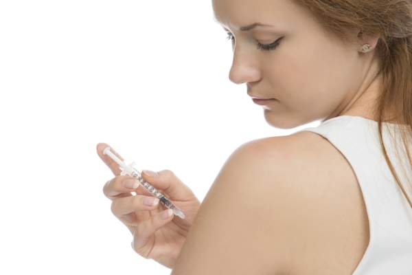 Young girl injection in arm.