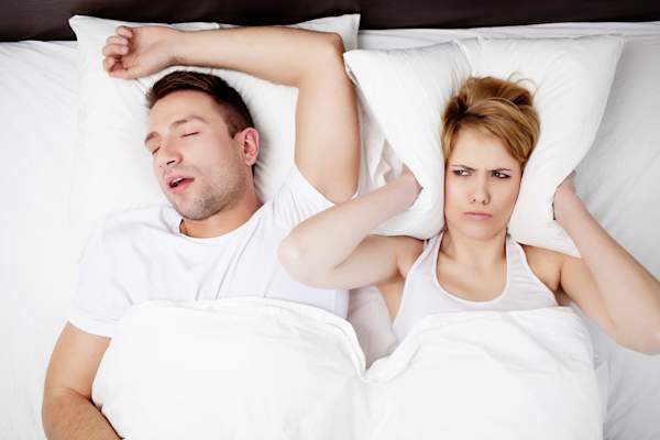 Snoring man keeping partner awake.