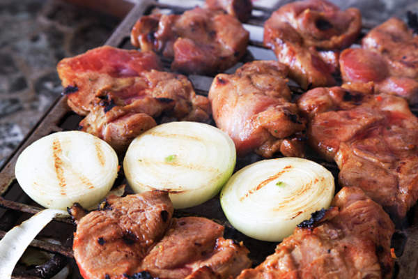 Onions on grill with marinated chicken