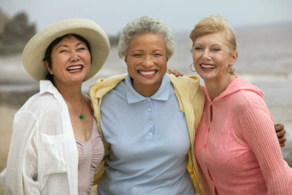 Happy senior women friends smiling.