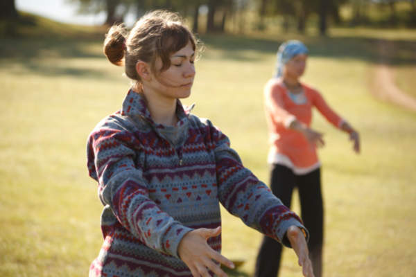 Women practicing gigong in the park.