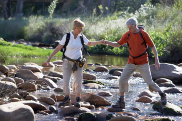 Couple hiking in stream.
