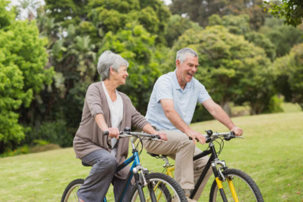 Couple bicycling together.
