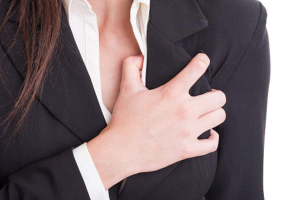 Woman clutching her chest.