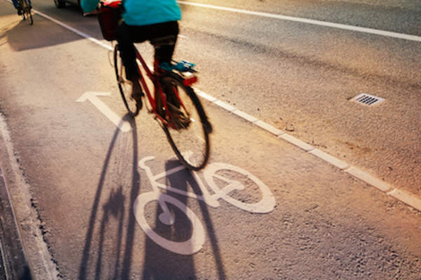 Woman biking down the street.