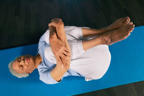 Woman doing yoga on mat.