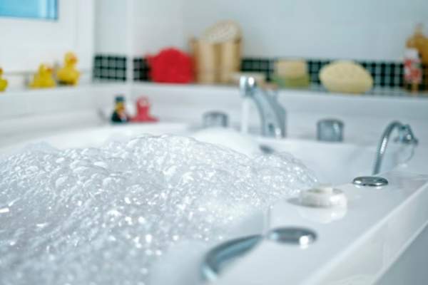 Bathtub filled with bubbles.