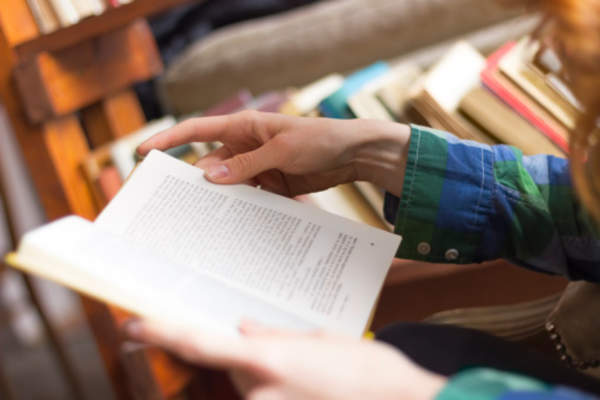 College student reading in library