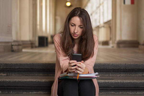 Student checking reminders on phone