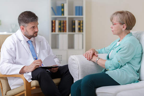 Senior woman talking to psychologist.