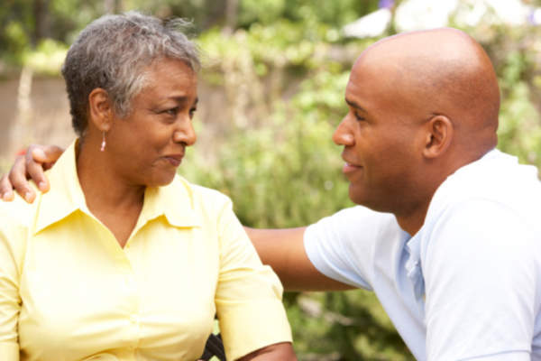 Senior couple talking and offering support to each other outside.