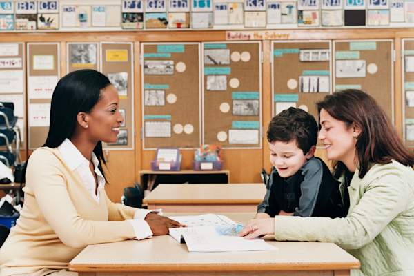 Mother and son meeting with teacher.