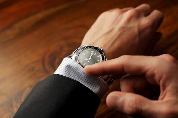 Man looking at watch.