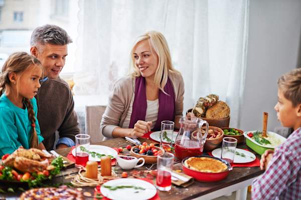 Man and woman talking at thanksgiving dinner.
