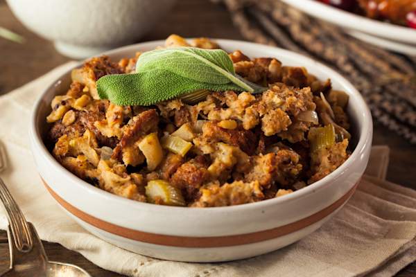 A bowl of stuffing with garnish.