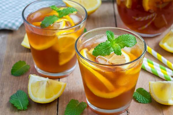 Two glasses of fresh iced tea with mint garnish.