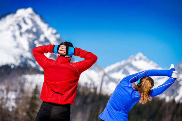 People stretching outside in the winter.