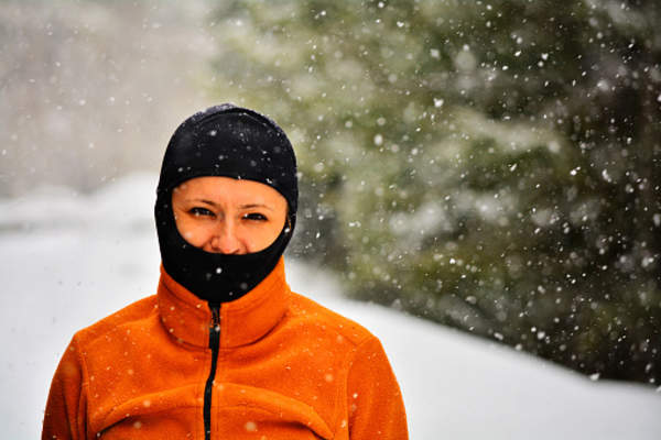Woman protecting herself from the snow and the cold.