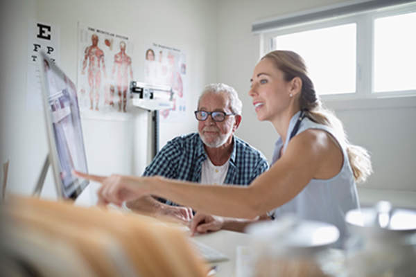 Doctor walking a patient through a cancer treatment plan.