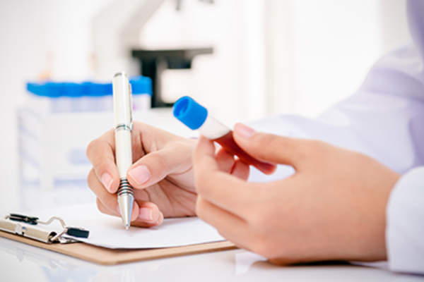 Doctor holding a blood vial.