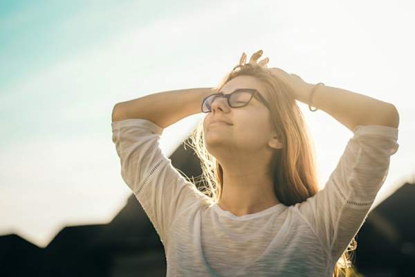woman with eyes closed looking relieved