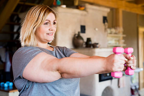 Woman exercising with arm weights.