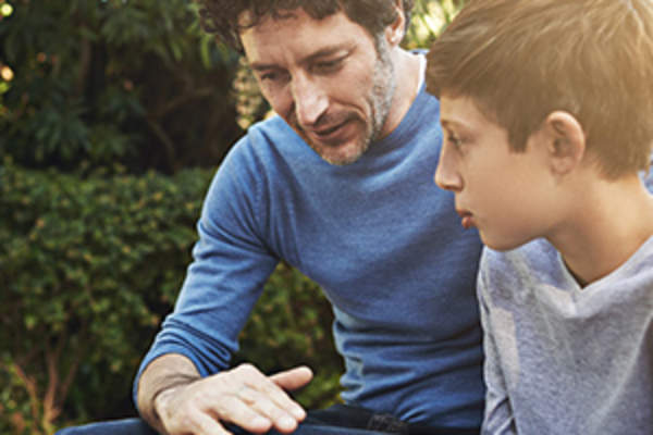 father talking to son image