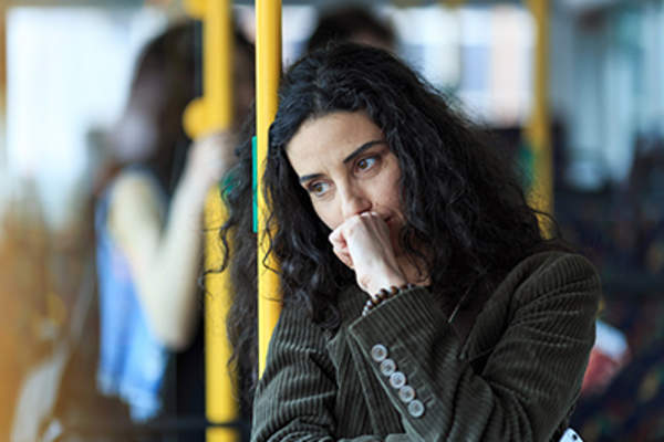 Depressed woman on a bus.