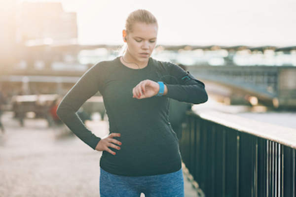 Woman checking her fitness tracker.