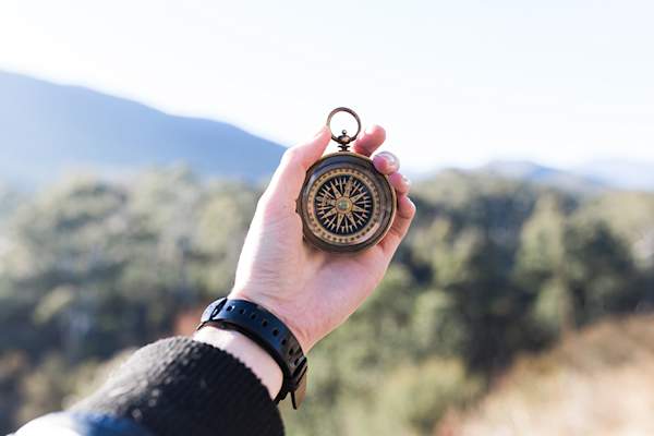 Person holding up a compass