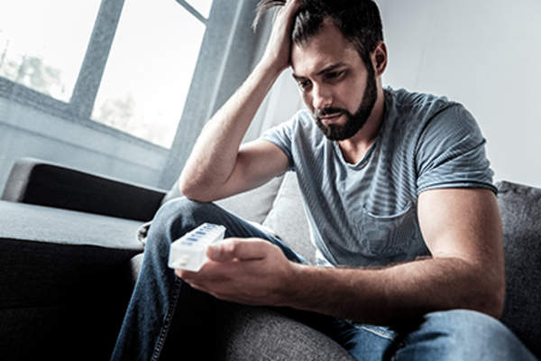 Man frustrated with his medication.