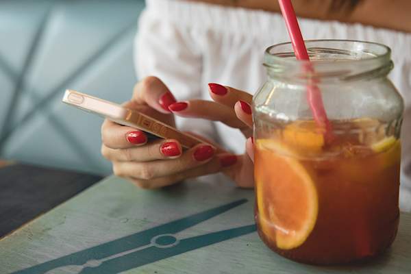 Woman's hand scrolling through phone