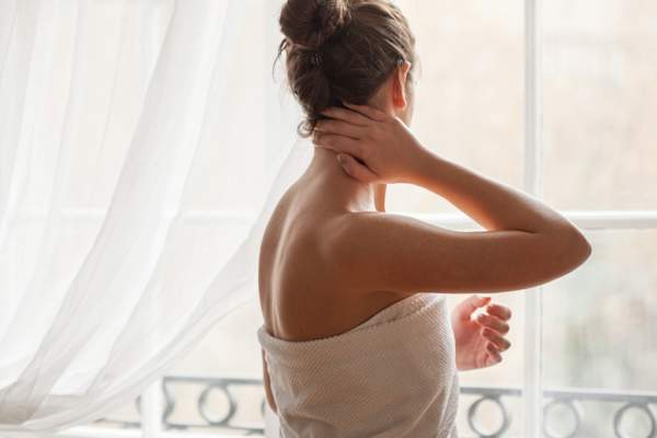 woman out of shower touching back of head