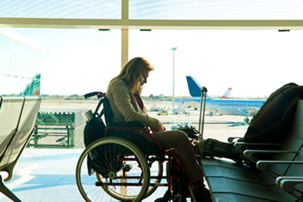 Disabled woman sitting in wheelchair at the airport