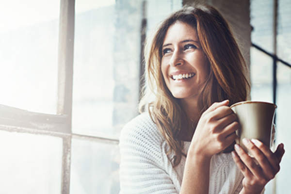 Smiling woman drinking coffee