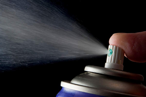Spraying from an aerosol can.