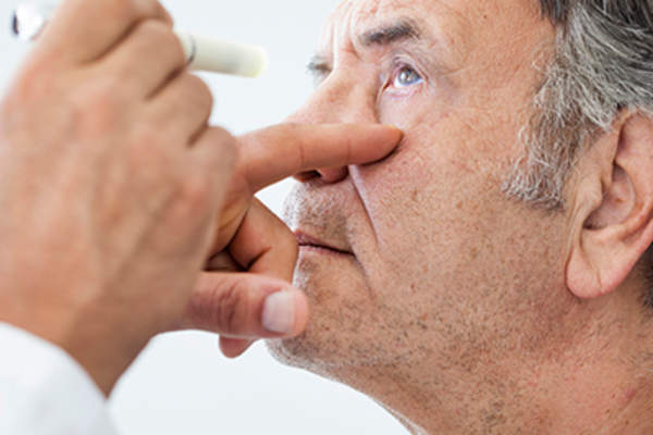 Senior man with eye drops.
