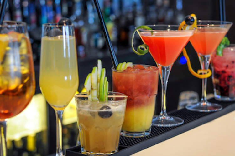 Line of cocktails on a bar.