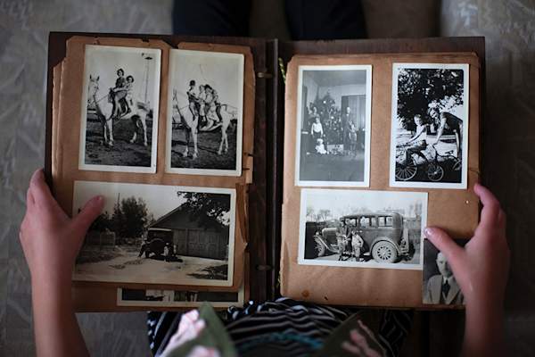 Person holding old photo album
