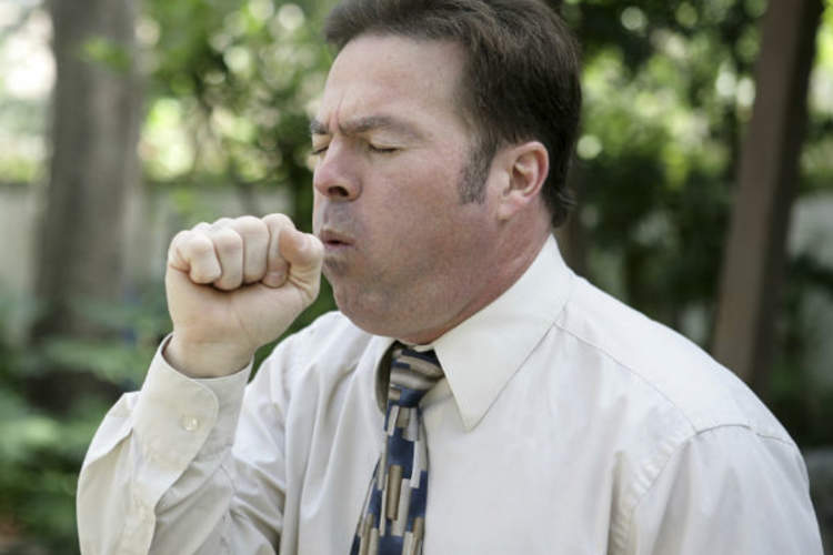 man coughing